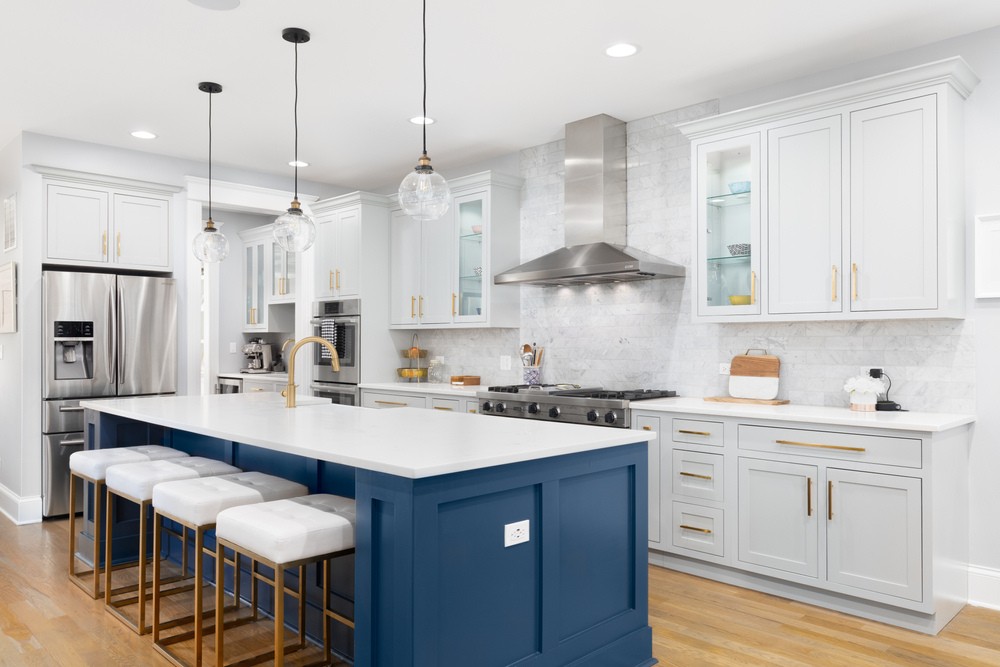 A beautiful modern kitchen with a blue island