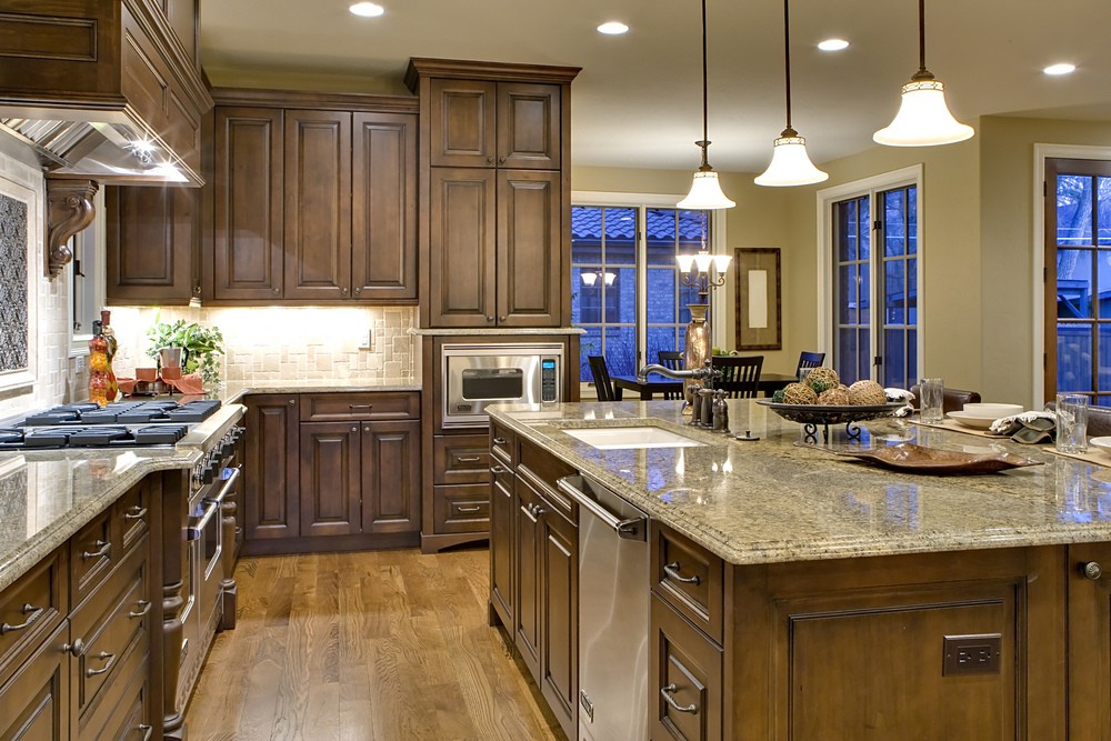 A farmhouse kitchen with wooden island and marble countertop