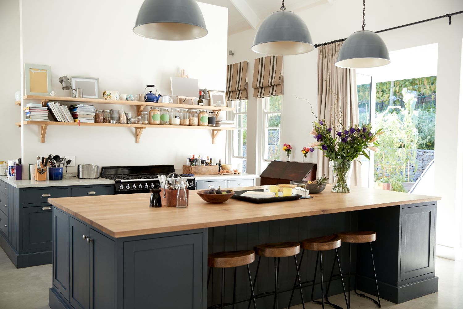 Big Navy Blue Island with 4 stools in a Kitchen