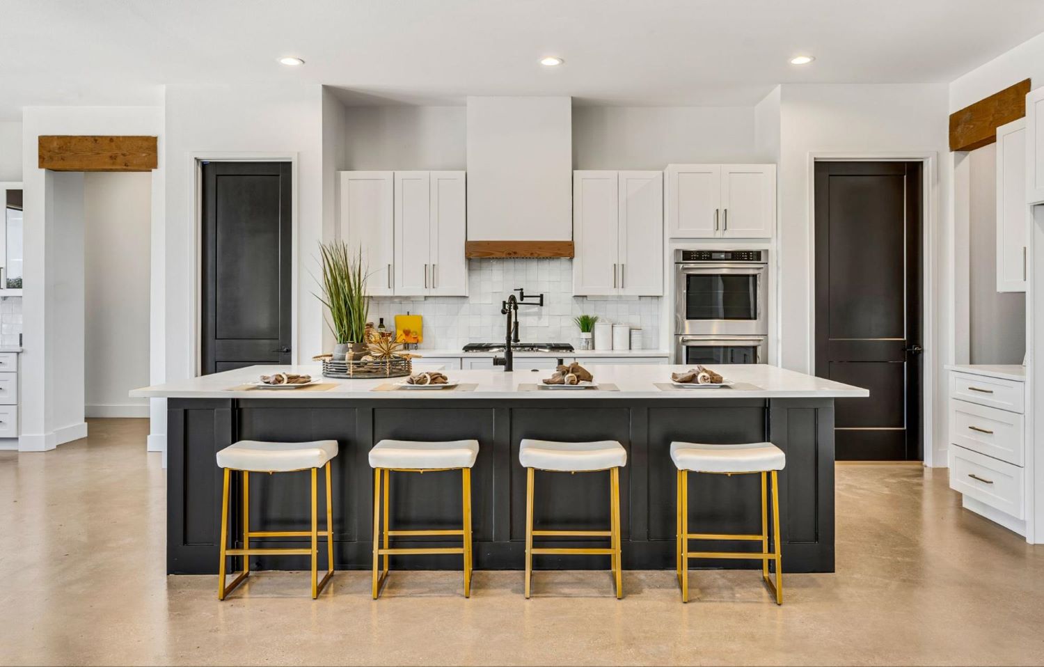 Black Island & White Countertop with Seating in a White Kitchen