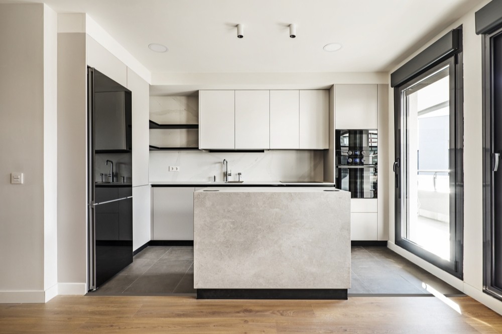 a modern kitchen with a marble island