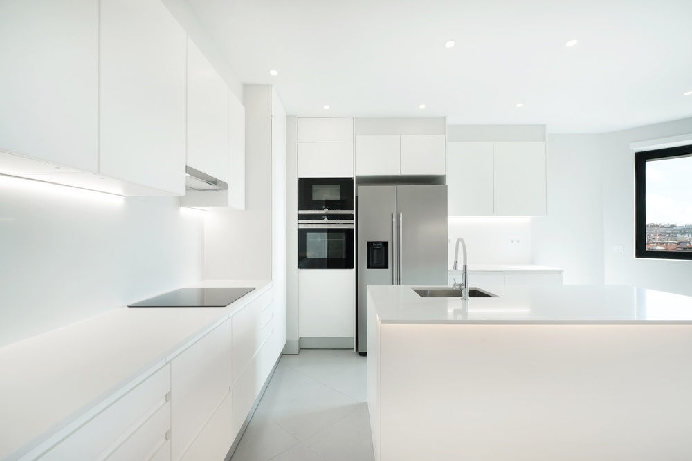 a modern pure white kitchen with an island