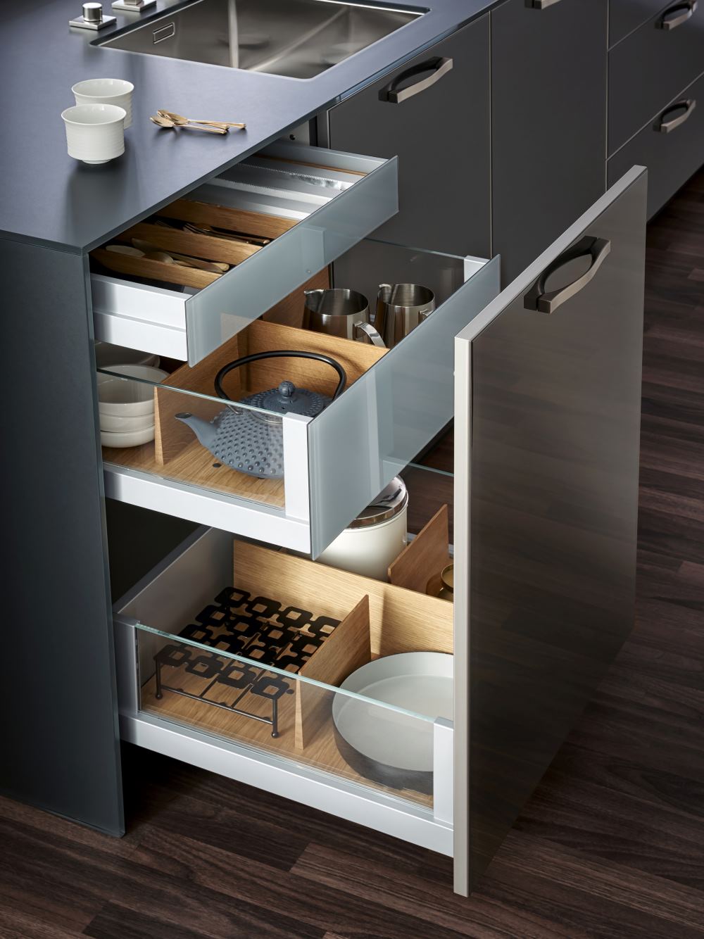 three drawers with organized utensils