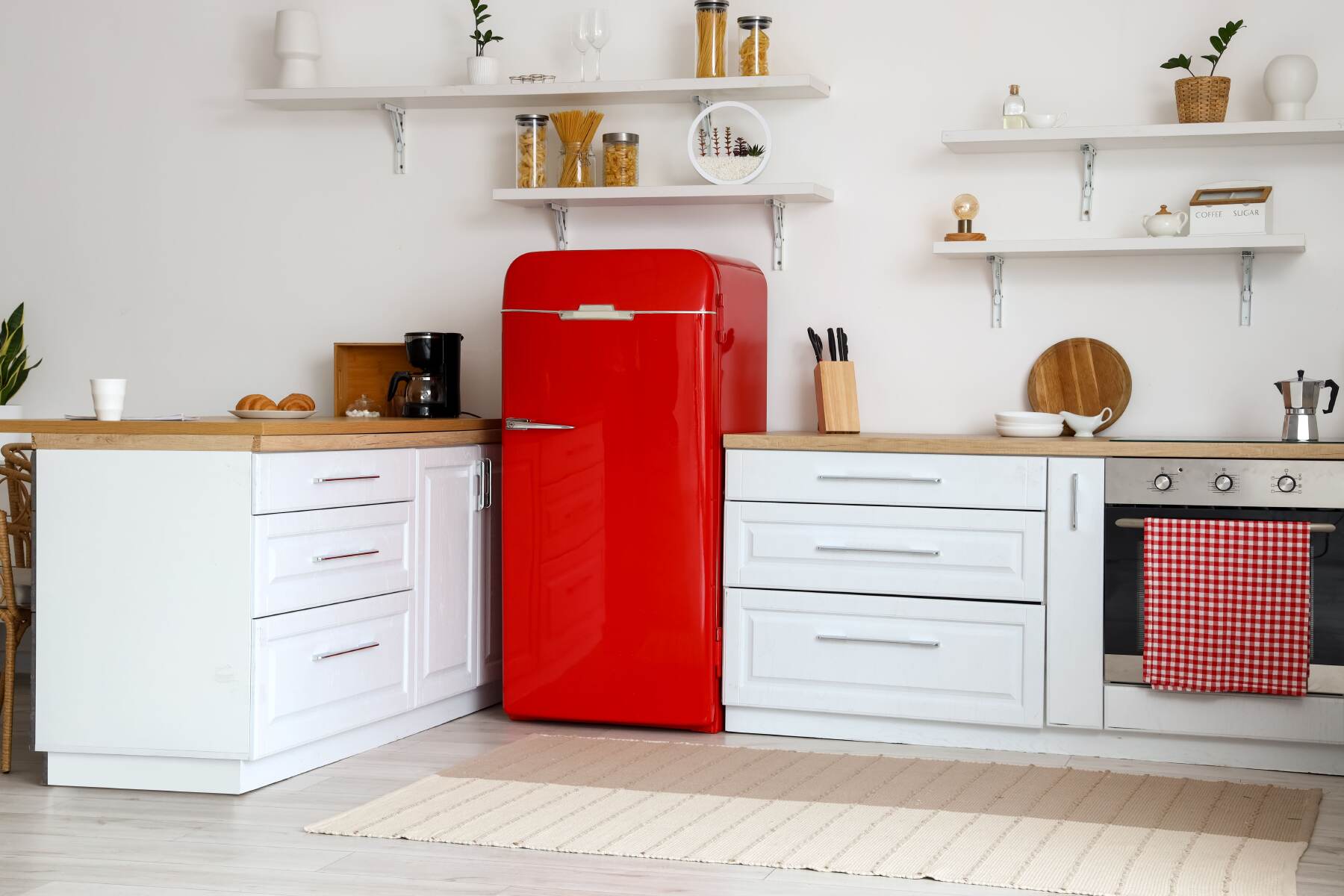 kitchen with white counters and red fridge