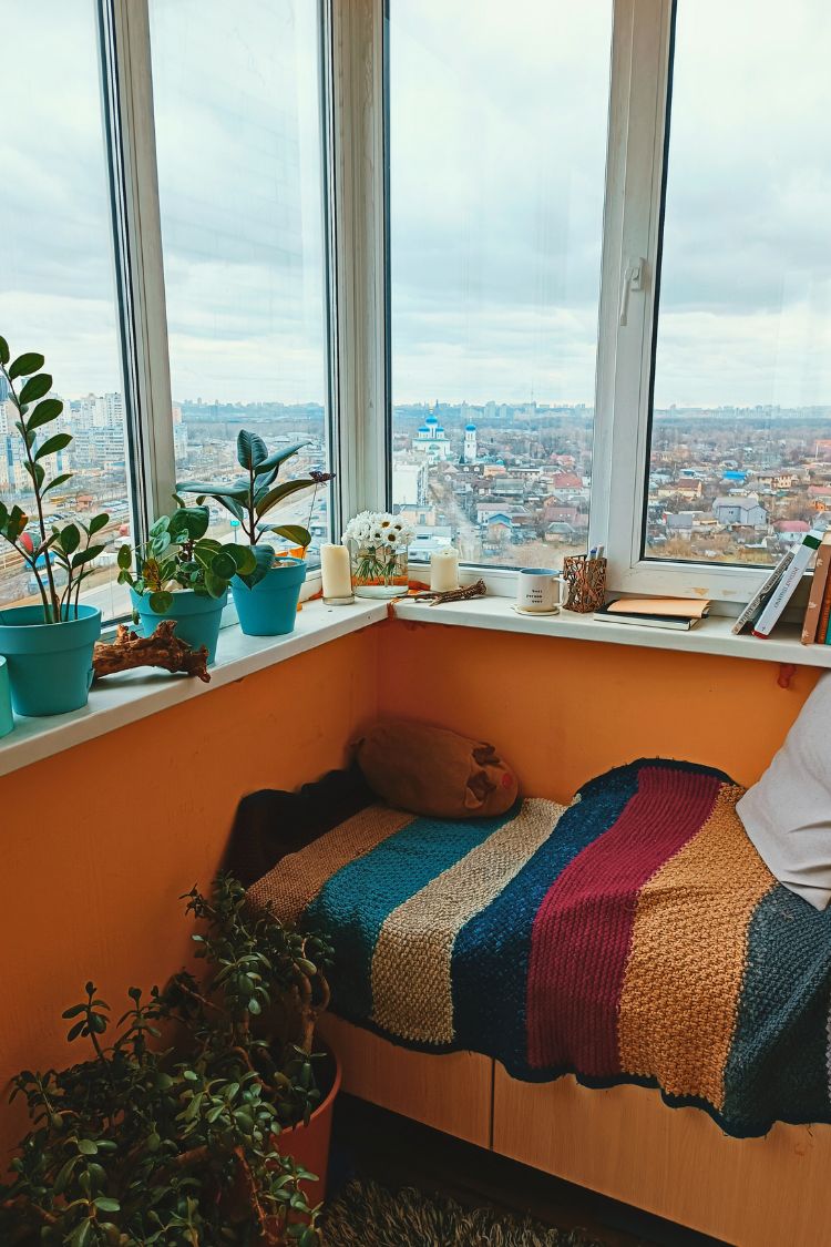 Bright boho balcony with striped blanket and sea view