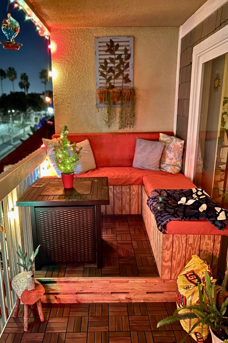 Colorful boho corner with red furniture and string lights