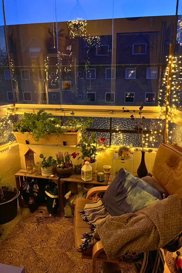 Cozy boho balcony with fairy lights and plush seating
