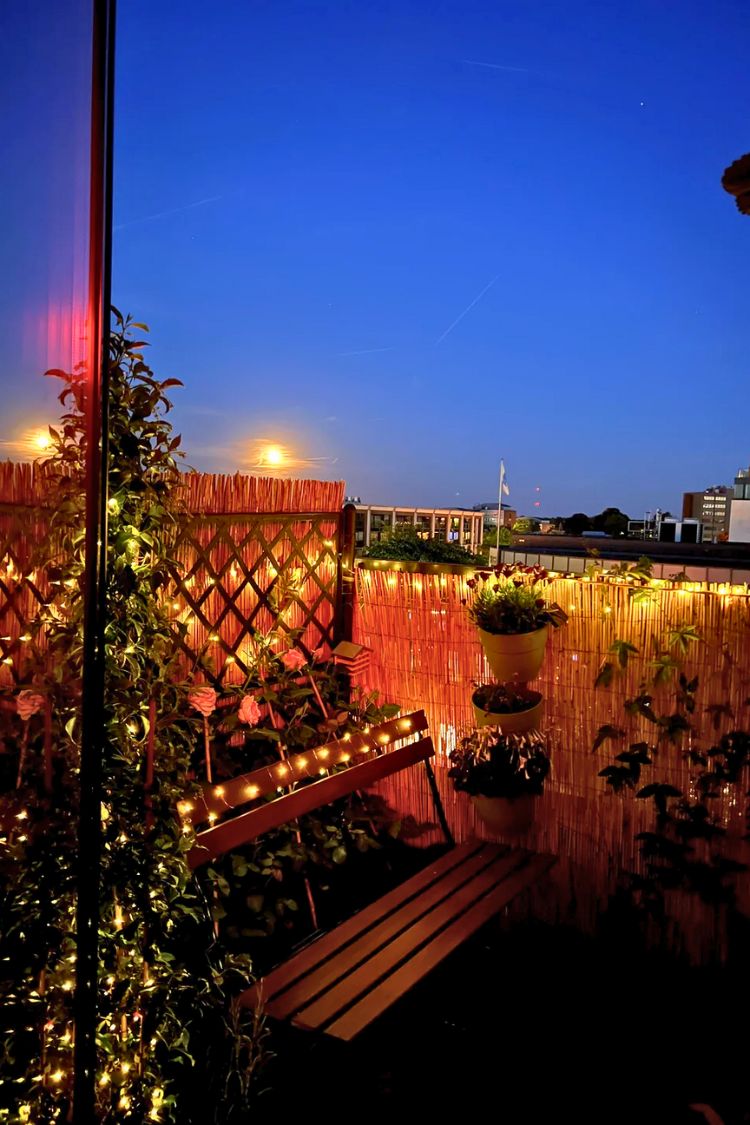Festive boho balcony lit up with fairy lights