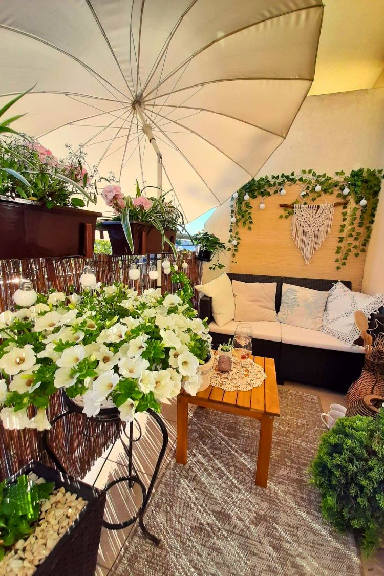 Floral boho balcony with umbrella and vintage bike