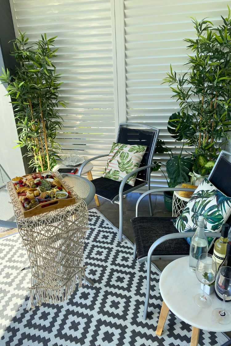 Monochrome boho balcony with rug and potted plants