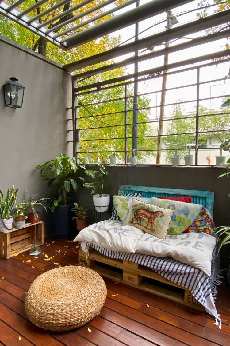 Serene boho space with wicker furniture and glass roof