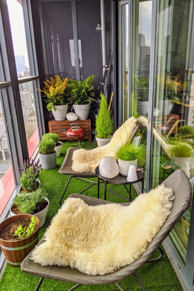 Small boho balcony with faux grass and cozy textures