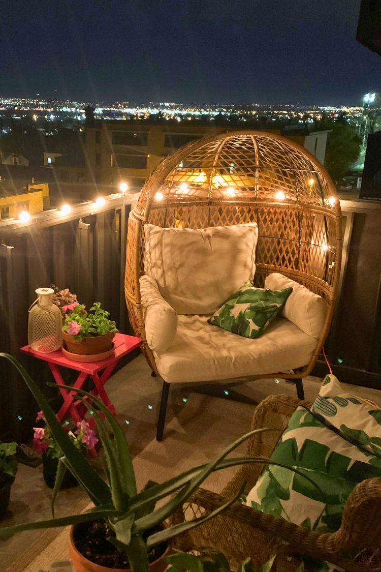 Warm boho evening setup with string lights and a rattan chair