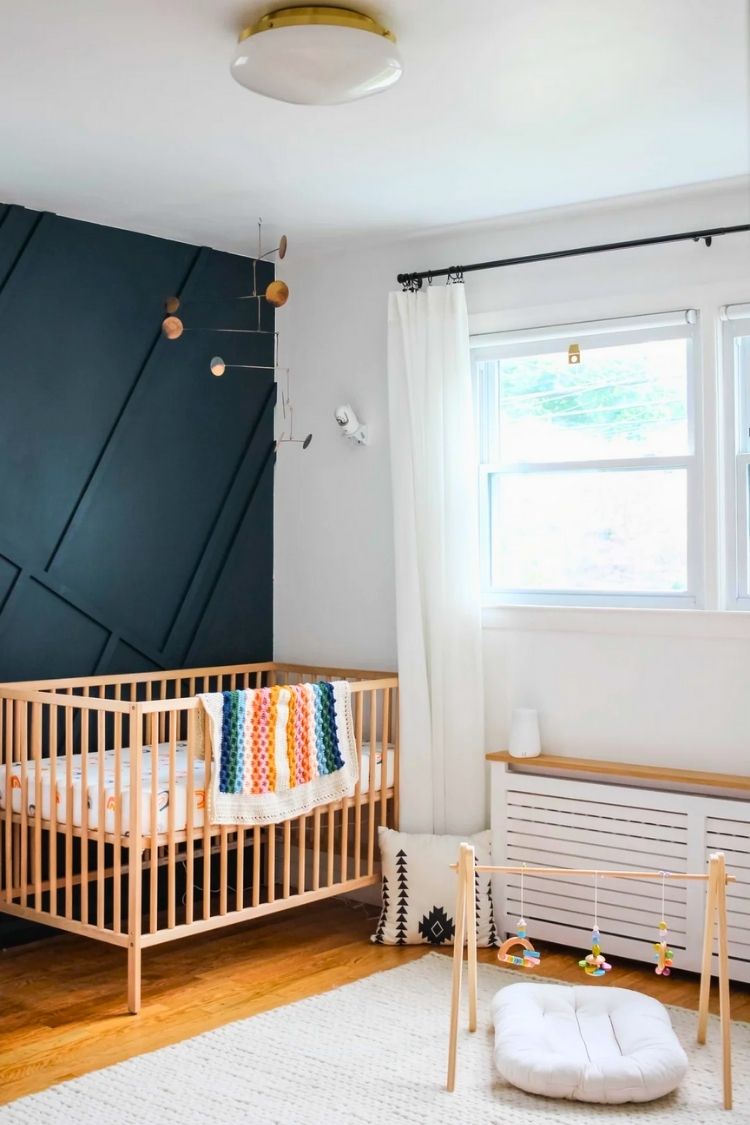 gender neutral boho nursery with navy wall