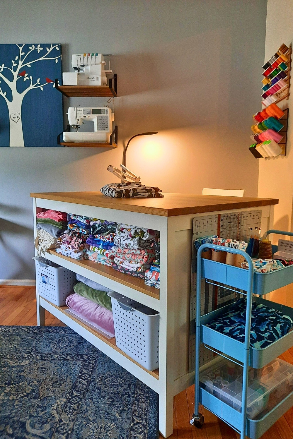 Functional Sewing Nook with Shelves and Rolling Cart in Living Room