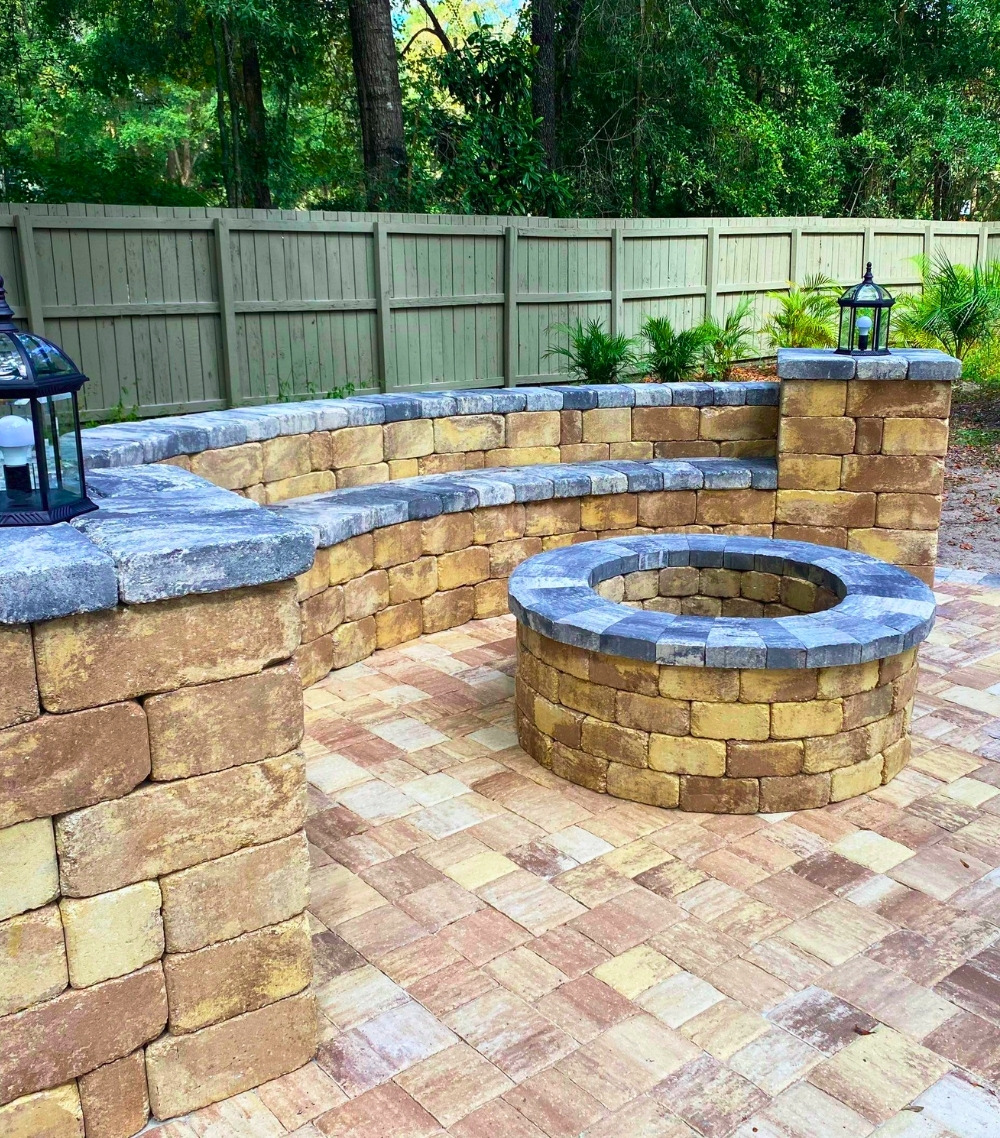 Modern Paver Patio With Round Stone Fire Pit and Curved Bench Seating
