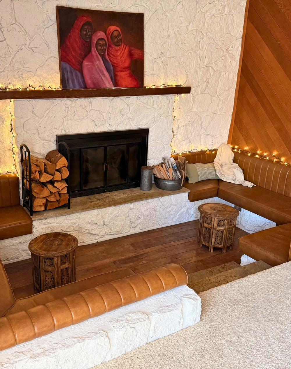Rustic Built-In Leather Pit With Fireplace and Personal Art