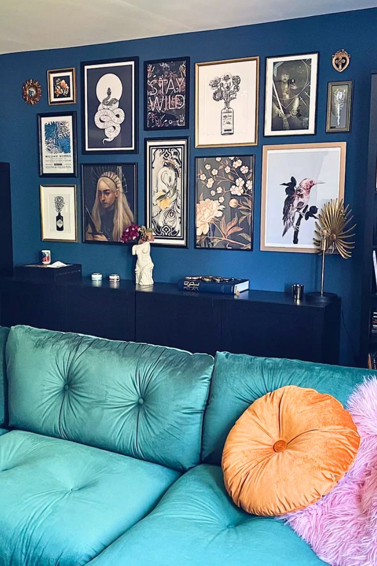 gallery wall above a blue couch