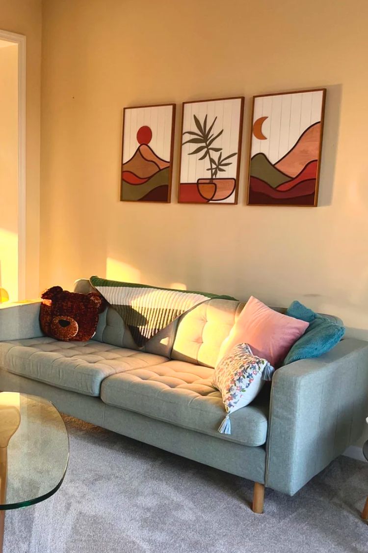 gallery wall above a gray couch