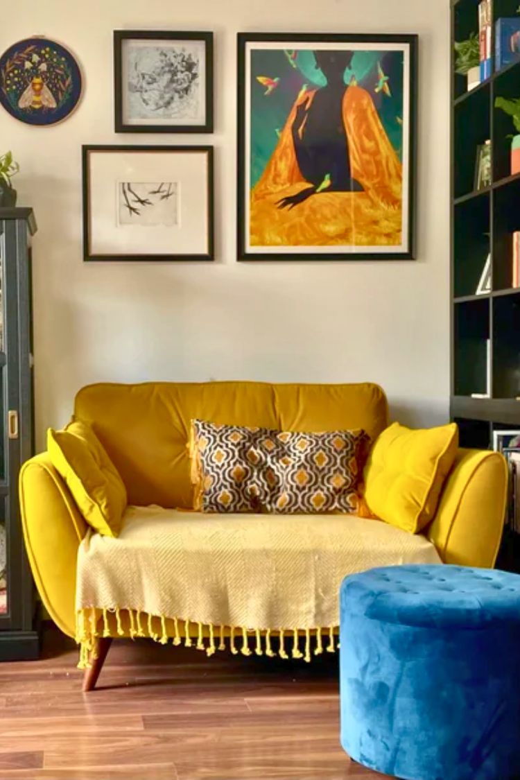 gallery wall above a yellow couch