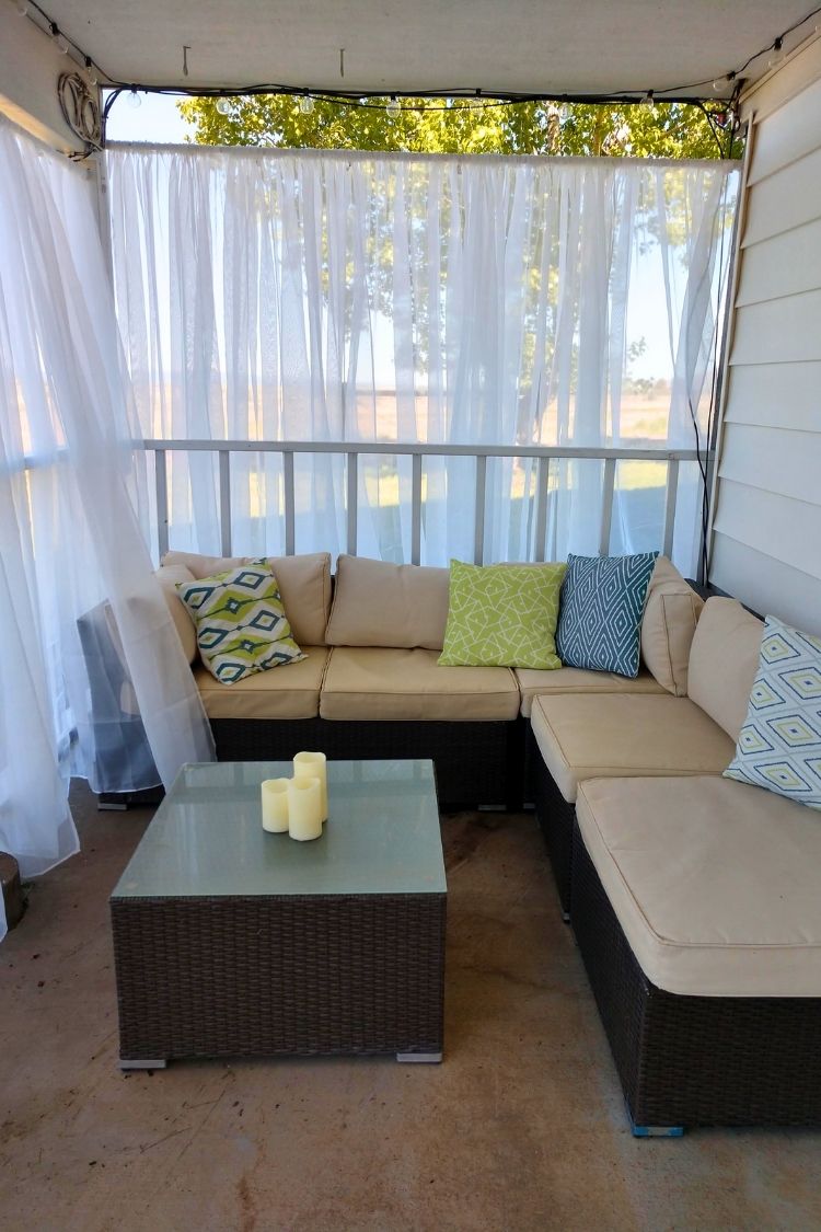 small apartment patio with sheer curtains