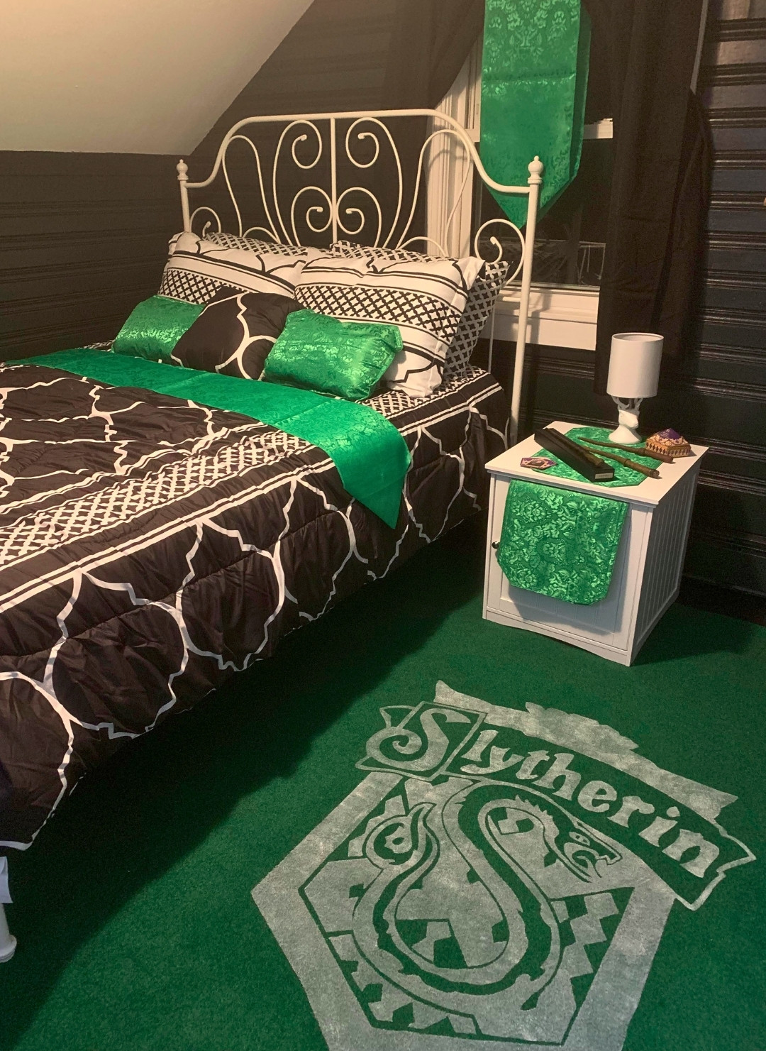 Bold Green Slytherin Guest Room With House Crest Rug and Simple Decor