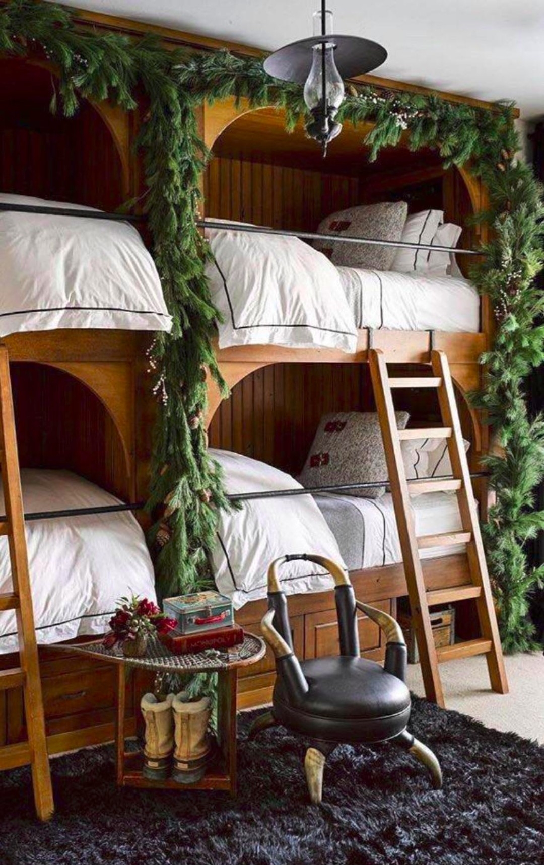 Rustic quad bunk bed with garland – cozy cabin style