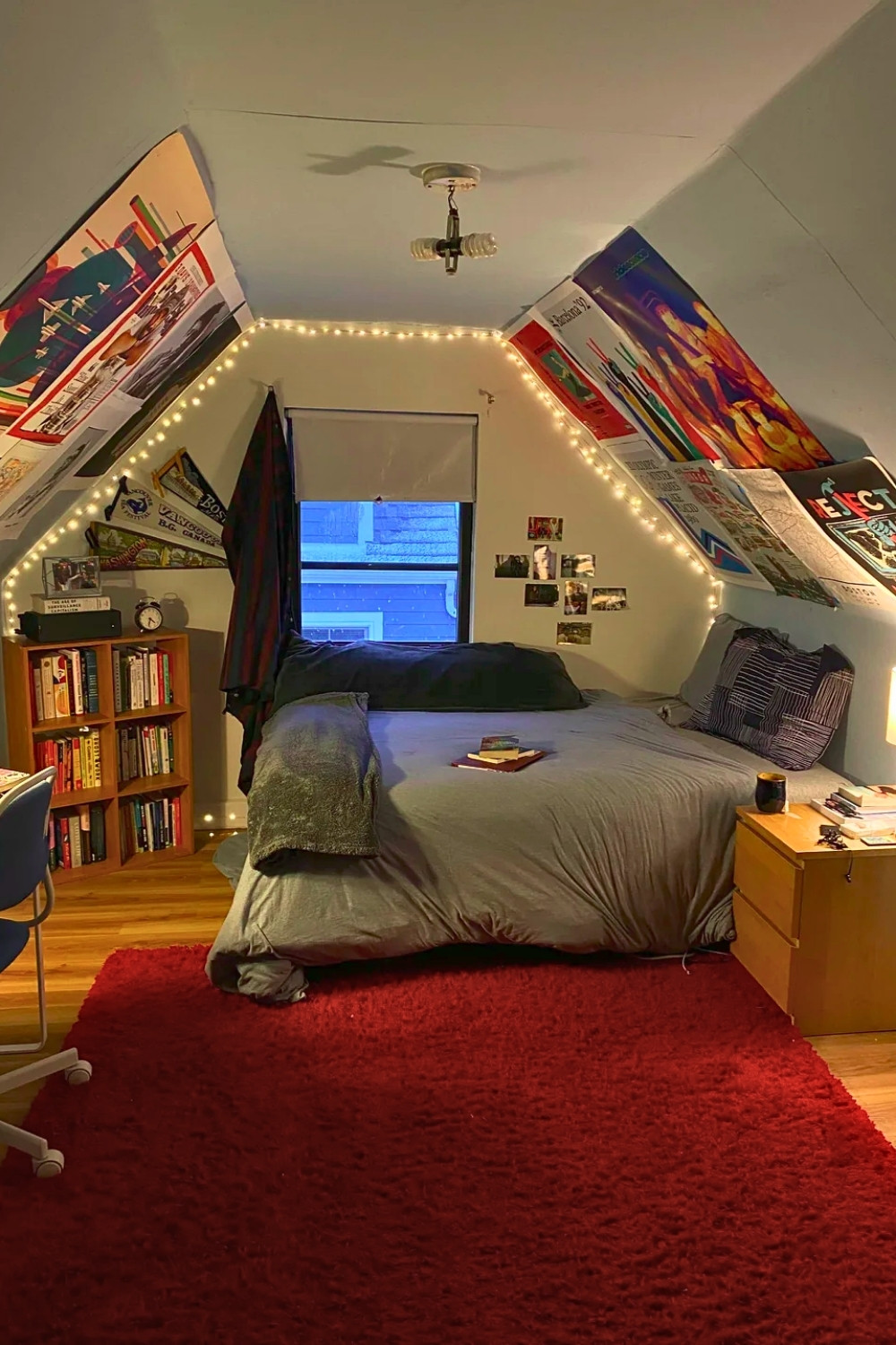 Cozy Attic Room With Posters String Lights and Grey Bedding