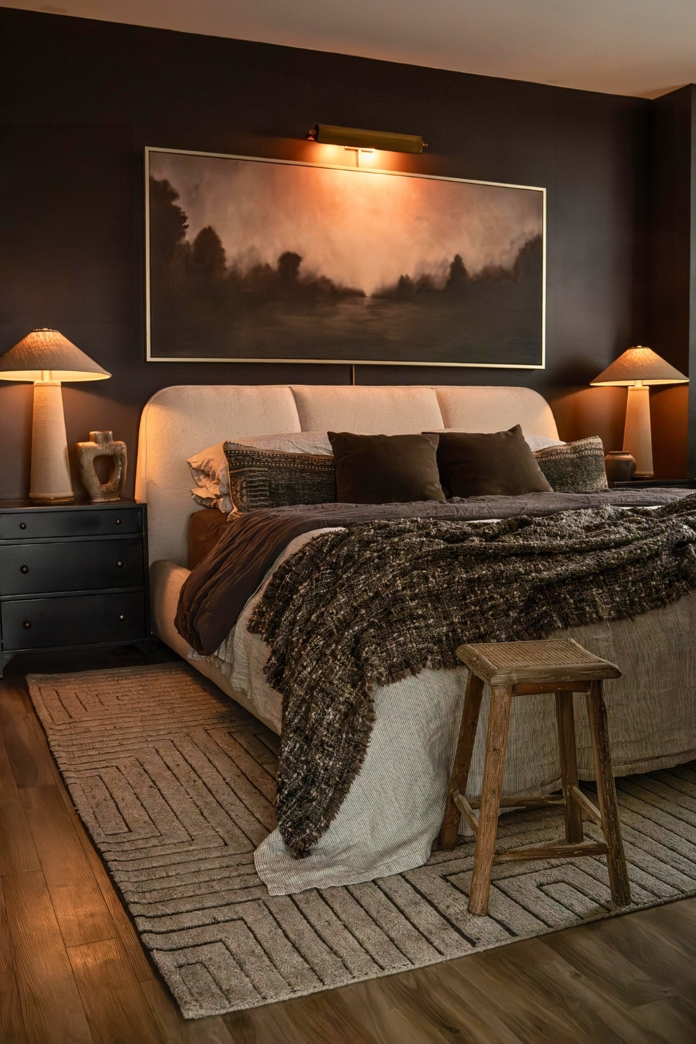 Moody Elegant Dark Bedroom With Warm Lighting and Textured Bedding