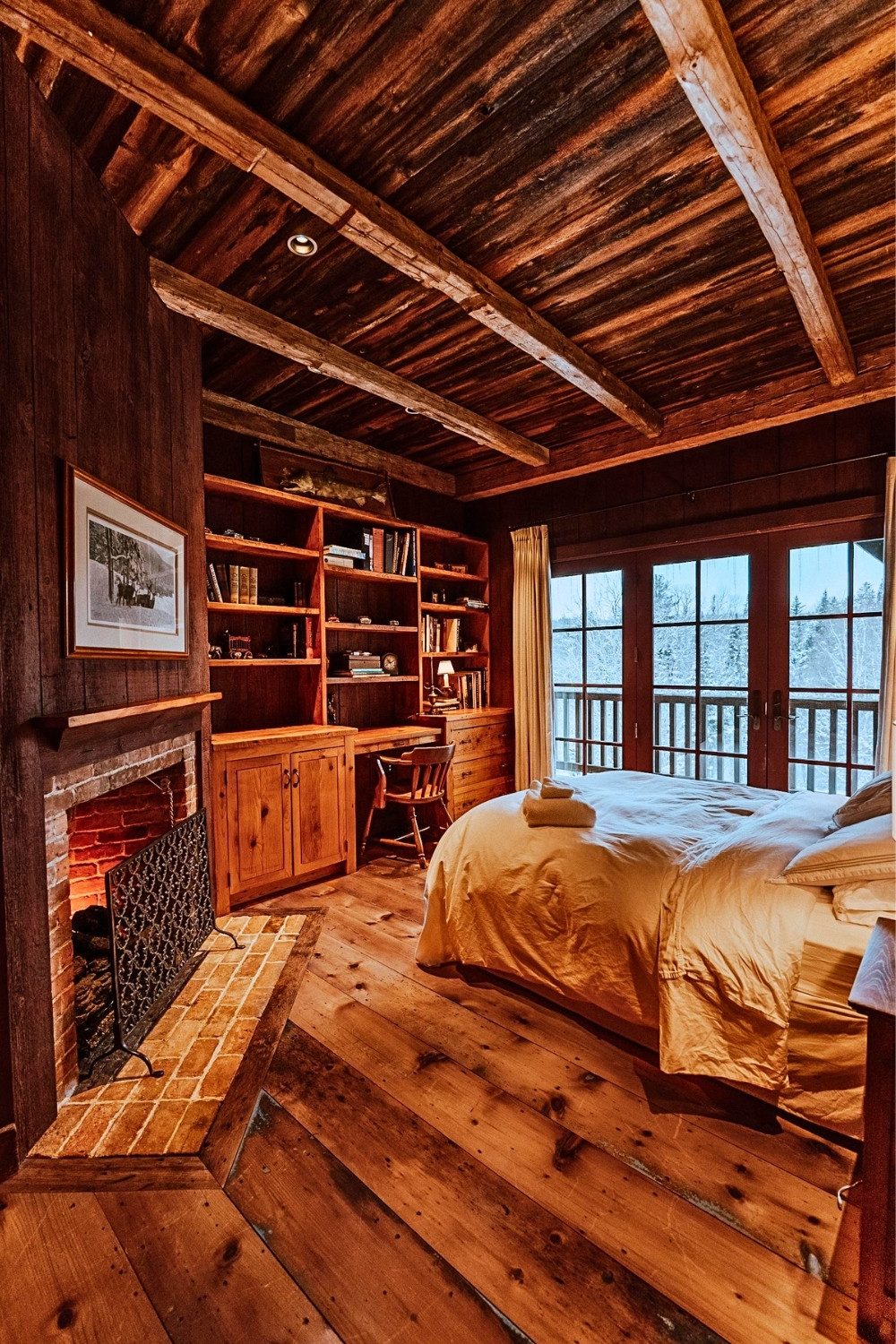 Rustic Cabin Bedroom With Fireplace and Warm Wood Decor