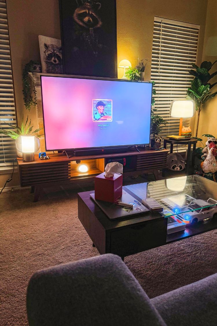 A dimly lit living room with a TV on a console table