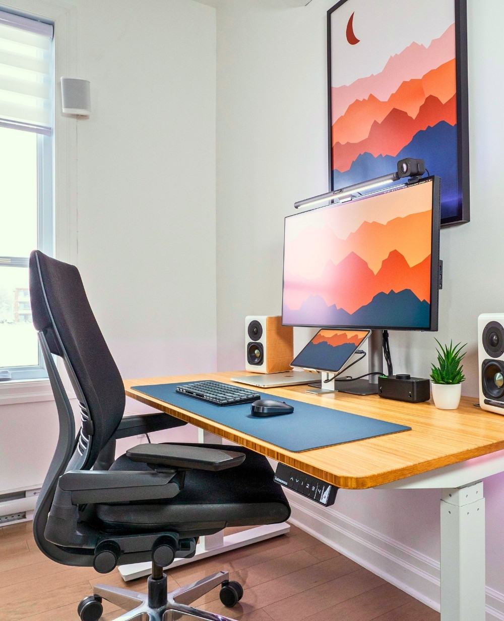 Minimalist Living Room Office Setup With Sleek Adjustable Desk And Neutral Decor