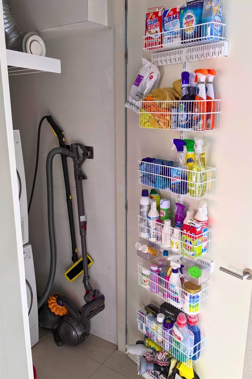 Organized Laundry Closet With Behind The Door Cleaning Supply Rack