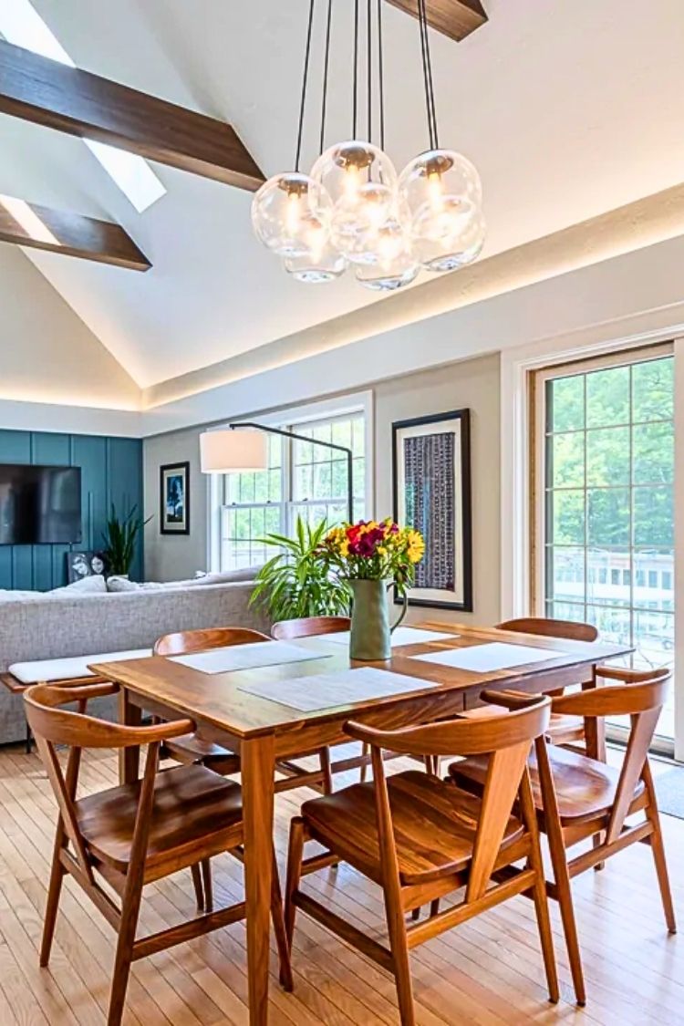 After – Airy dining space with sloped ceiling and large windows