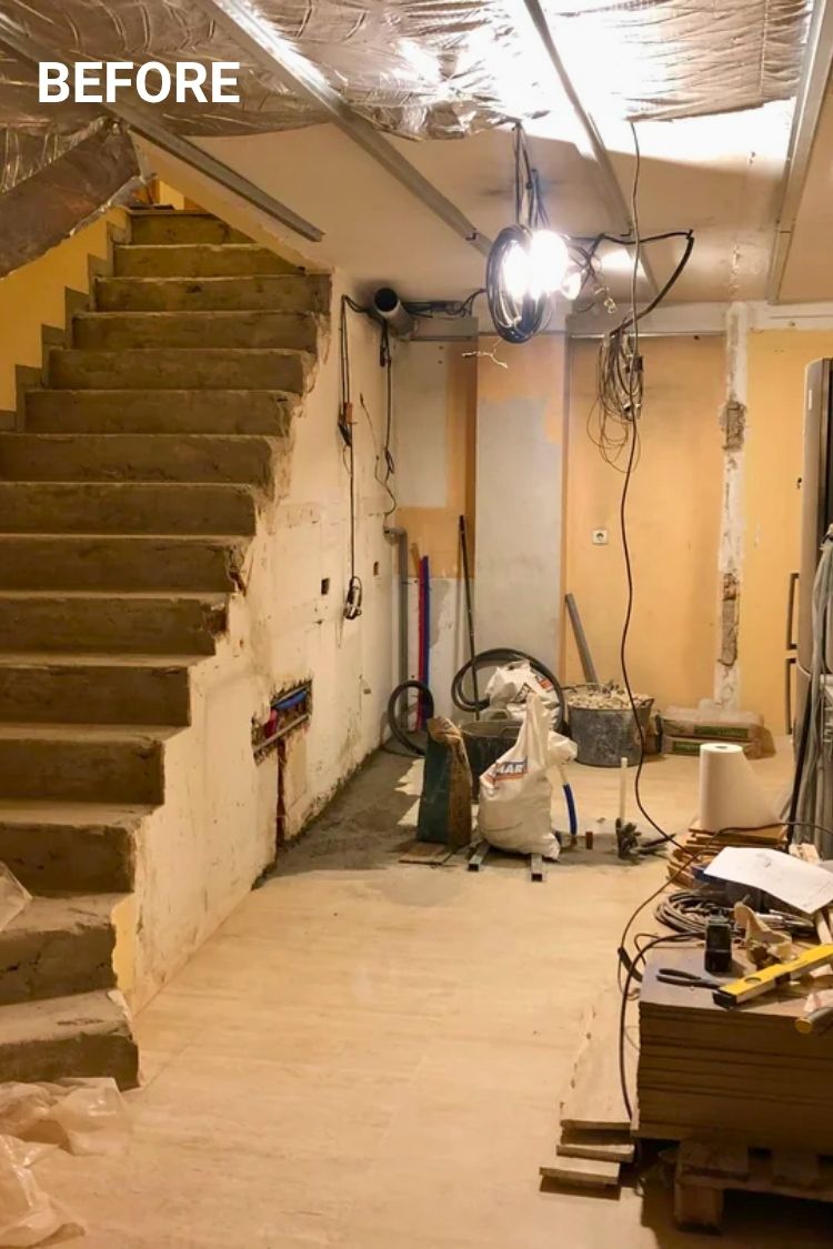 Before - Unfinished basement with tools and stairs