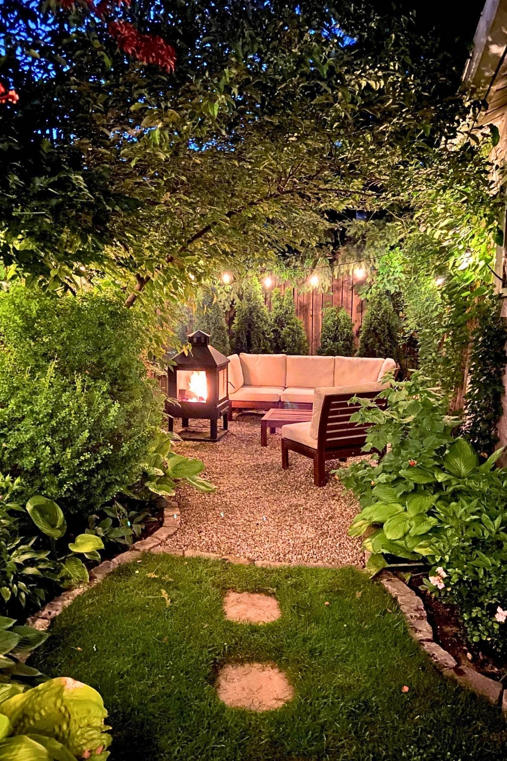 Cozy Backyard Oasis With Fireplace and String Lights