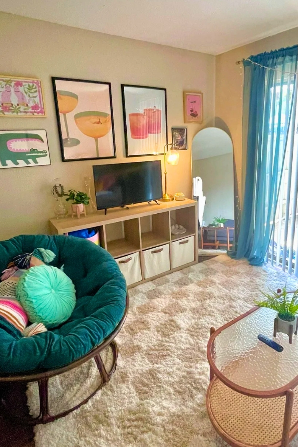 Small Apartment Cozy Living Room With Colorful Wall Art And Teal Papasan Chair